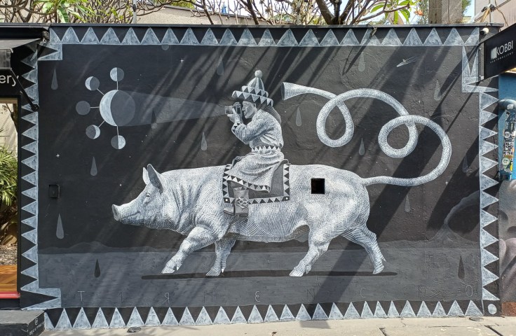 Man riding a pig mural in Vila Madalena